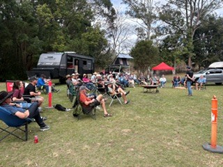 An RV group sitting together on the camping lawn
