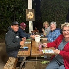 Campers playing bingo around a table