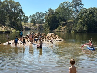 Campers swimming and paddling in Yabba Creek